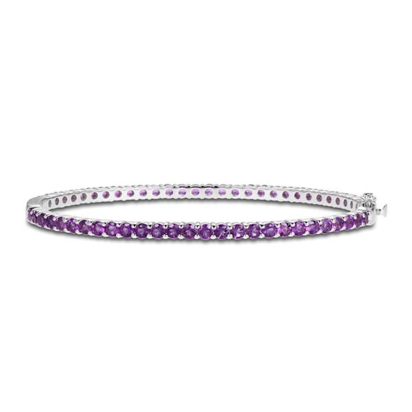 Vibrant round amethysts adorn this sophisticated bangle fashioned in classic sterling silver. The bracelet measures 7.25 inches and secures with a box clasp. Elegant Amethyst Bracelets For Anniversary, Elegant Amethyst Bracelet For Anniversary, Classic Gemstone Bangle For Anniversary, Elegant Purple Gemstone Bracelets, Elegant Purple Tennis Bracelet, Bangle With Sterling Silver Clasp, Classic Amethyst Bracelets, Elegant Adjustable Purple Bangle, Formal Round Amethyst Bracelets