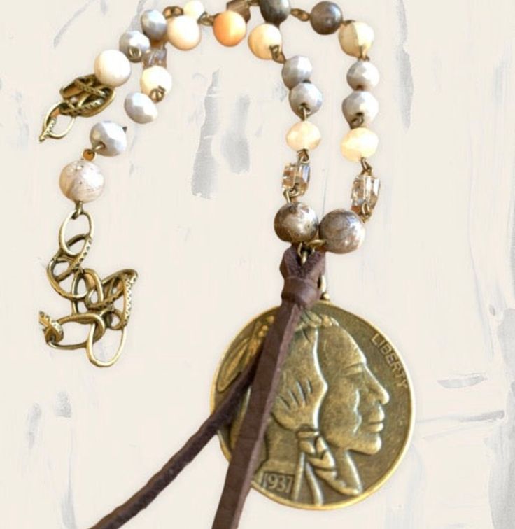 *18" Long *Color: Earth Tones and light blue *Medallion is double sided and can be worn either way by flipping the necklace *Hardware is antique bronze *Leather embellishment Antique Gold Adjustable Jewelry For Vintage Collection, Bohemian Medallion Necklace With Vintage Charm, Bohemian Medallion Necklace From Vintage Collection, Adjustable Bohemian Jewelry With Antique Finish, Adjustable Bronze Patina Necklaces, Adjustable Brown Vintage Necklace, Vintage Brown Adjustable Necklace, Adjustable Medallion Coin Necklace, Antique Adjustable Necklaces For Festivals