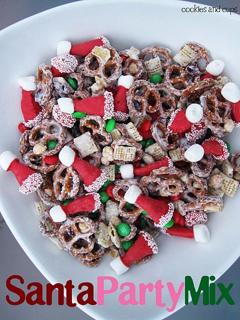 a white bowl filled with candy and pretzels