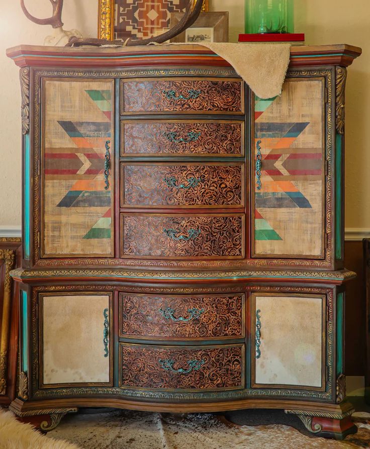 an old dresser has been painted with colorful designs