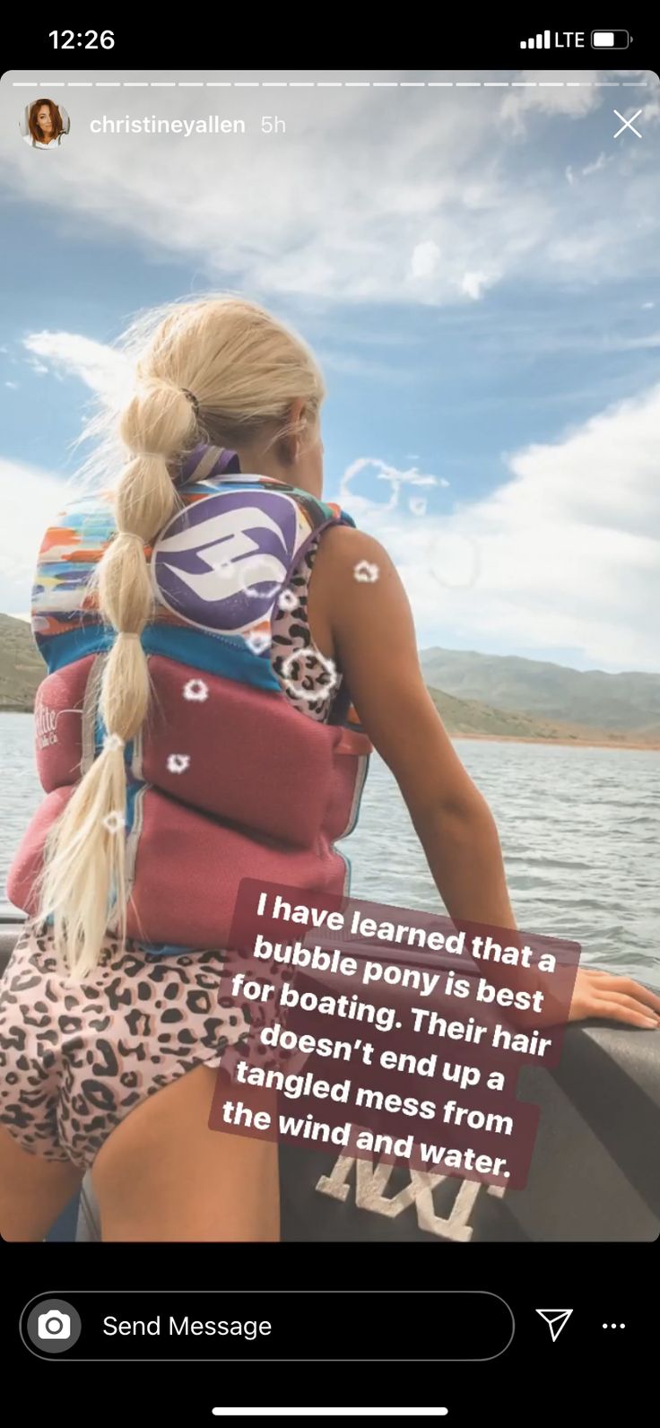 a woman sitting on the back of a boat with a life vest over her shoulder