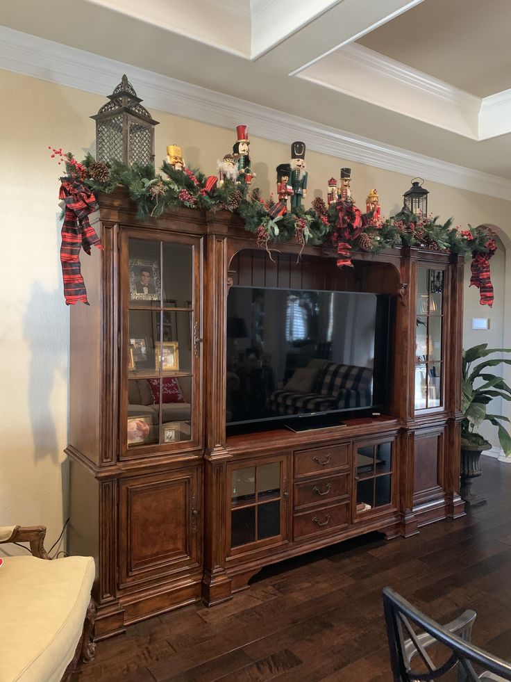 the entertainment center has christmas decorations on it