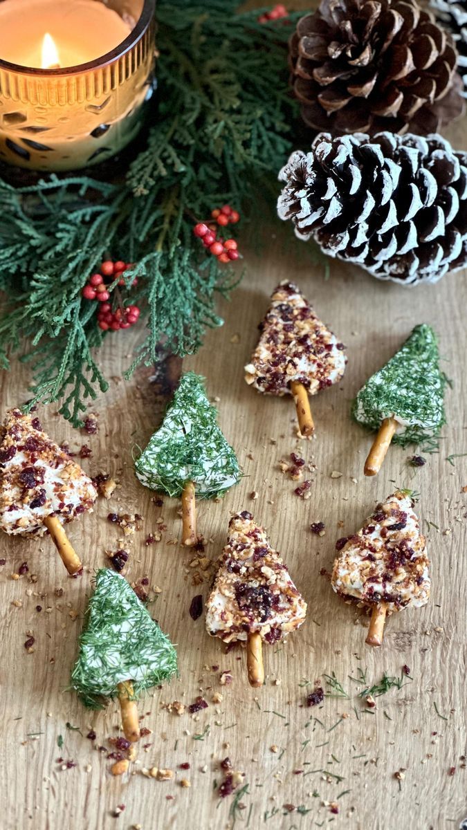 christmas treats are arranged on a table next to pine cones