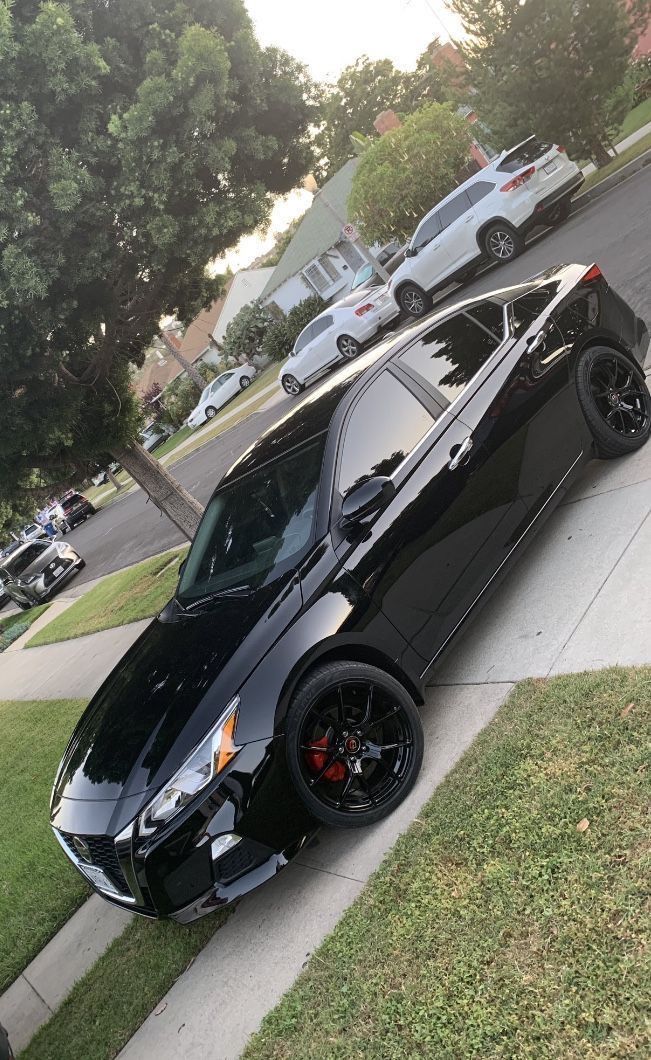 a black car parked on the side of a road