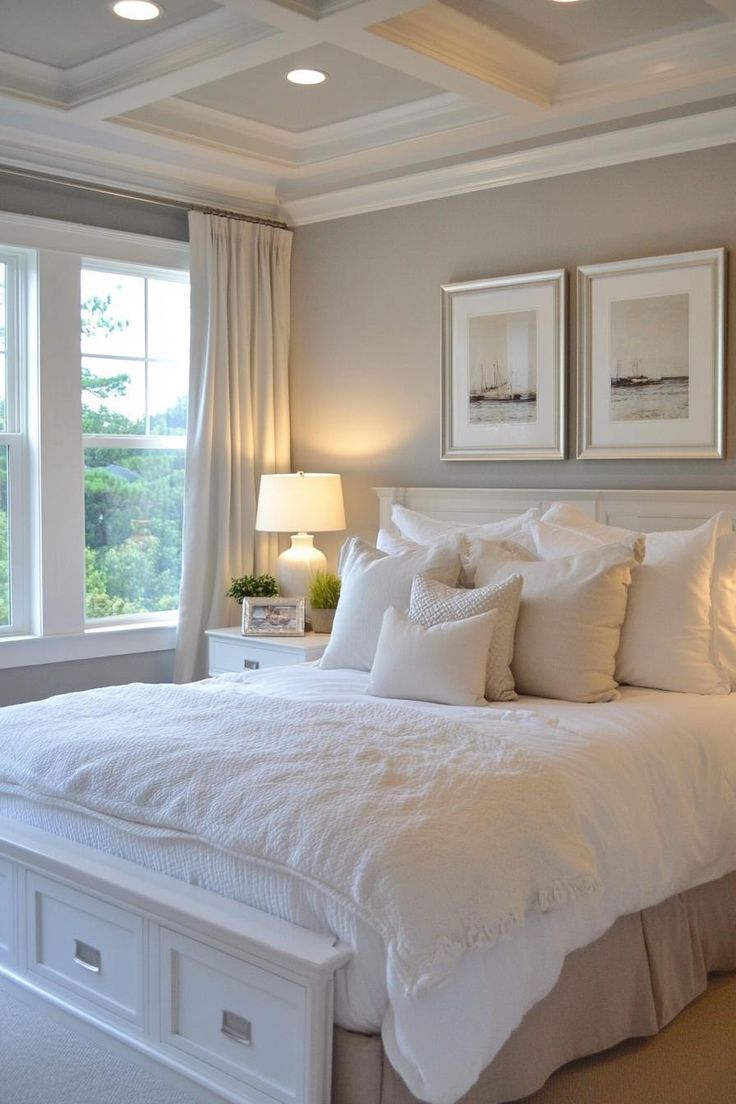 a white bed sitting in a bedroom next to two windows