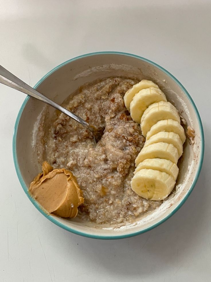 a bowl of oatmeal with bananas and peanut butter