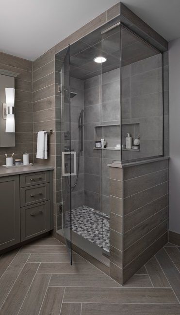 a bathroom with a walk in shower next to a sink