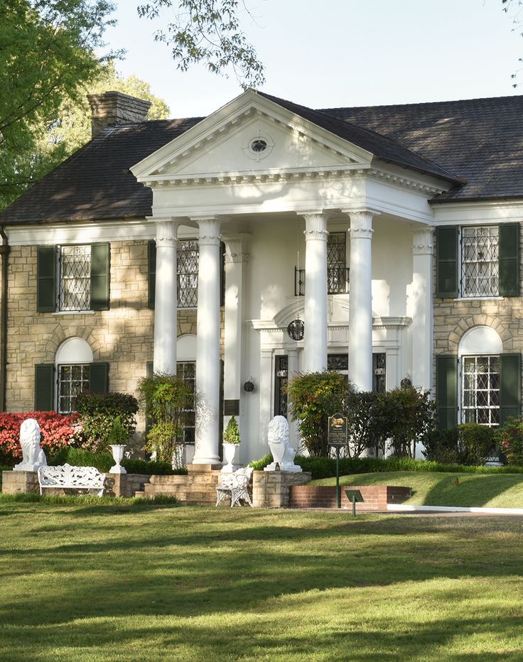 a large white house with columns and green shutters