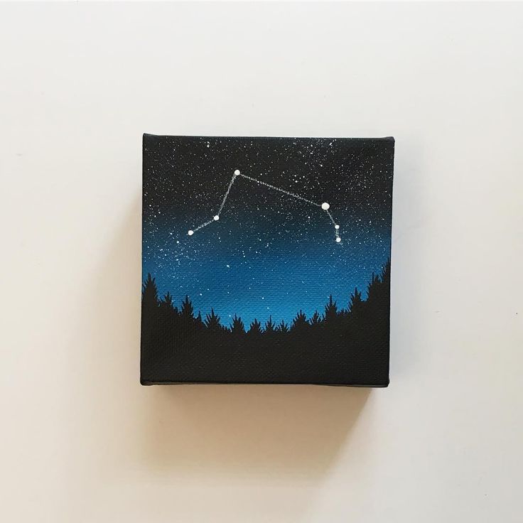 a painting of the night sky with stars and trees on it, in front of a white wall