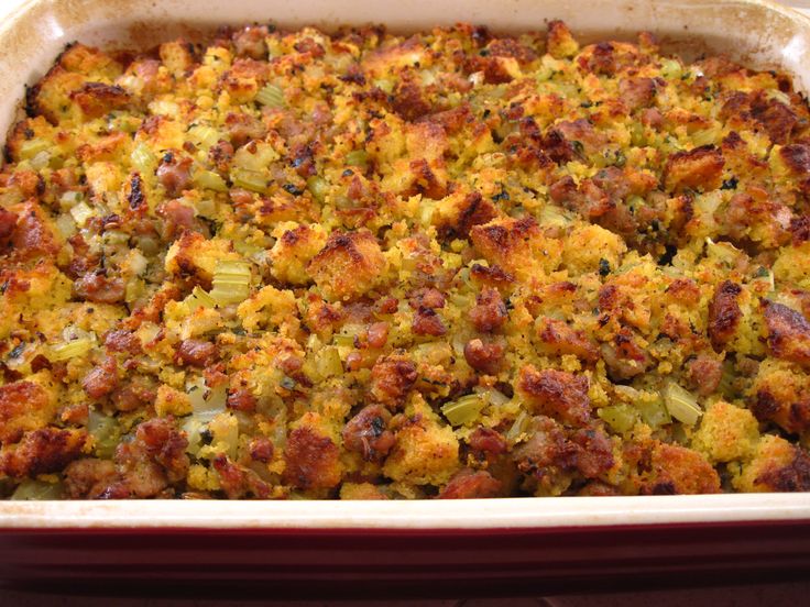 a casserole dish filled with stuffing and vegetables