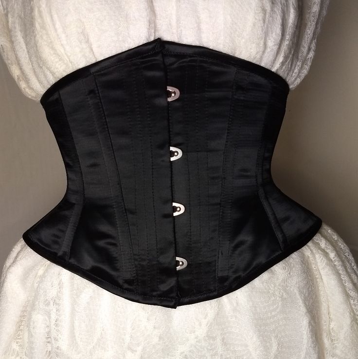 A Black Satin Corset With 100% Steel Boning, Busk Closure And Black Lacing Ribbon In The Back. A Cincher Length At 9" From Top To Bottom With High Hips And Conical Shaped Rib. Several Sizes Are Available And Note That The Size Listed Will Be The Total Inch Measurement When The Corset Is Closed. All Are New Without Tags! Elegant Black Corset For Wedding, Elegant Black Wedding Corset, Wedding Black Fitted Corset Belt, Elegant Wedding Corset Belt With Boning, Formal Black Corset With Boning, Elegant Black Corset Belt For Weddings, Elegant Black Corset Belt With Boned Bodice, Elegant Underbust Corset Belt, Classic Black Fitted Corset