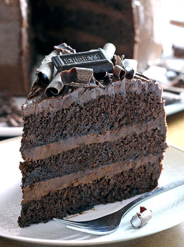 a piece of chocolate cake sitting on top of a white plate