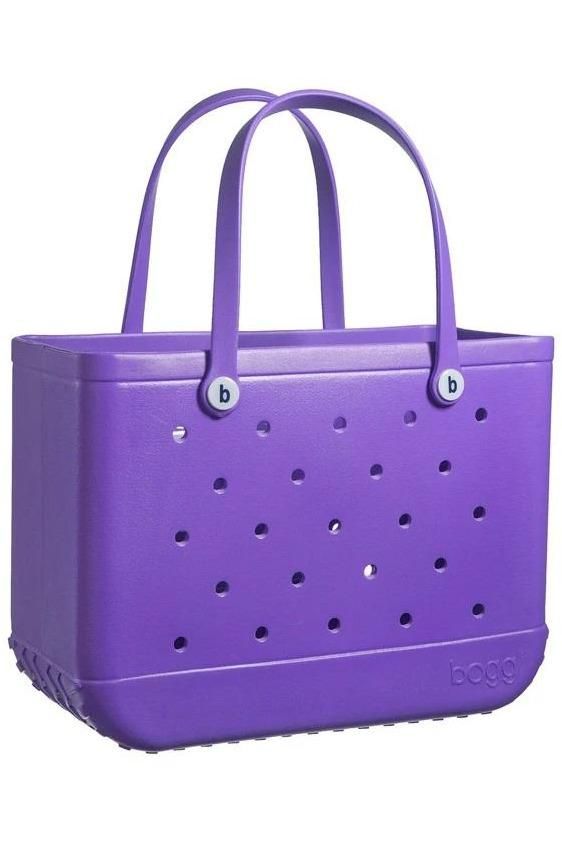 a purple tote bag with holes on the front and bottom, sitting against a white background