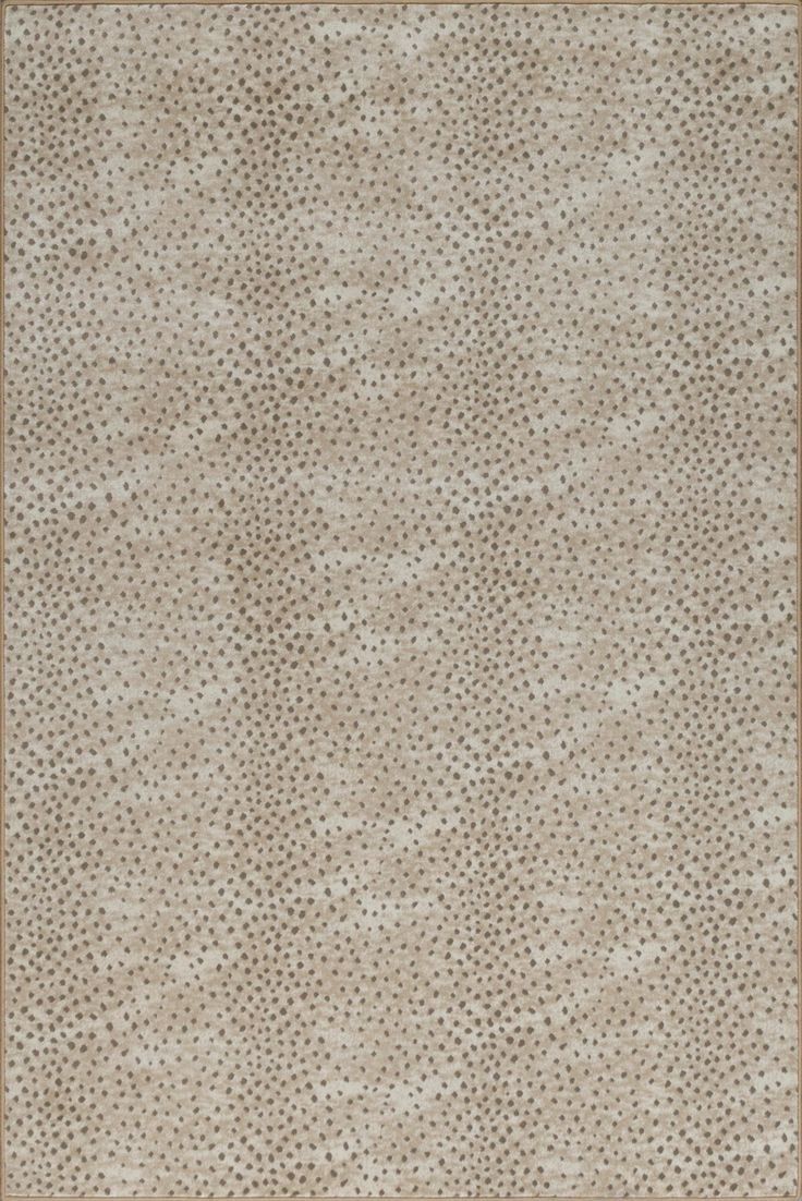 a beige rug with small dots on it