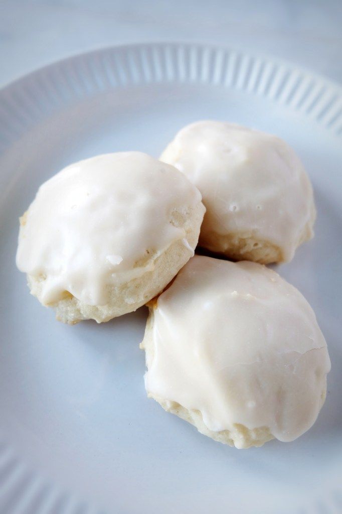 three glazed donuts on a white plate