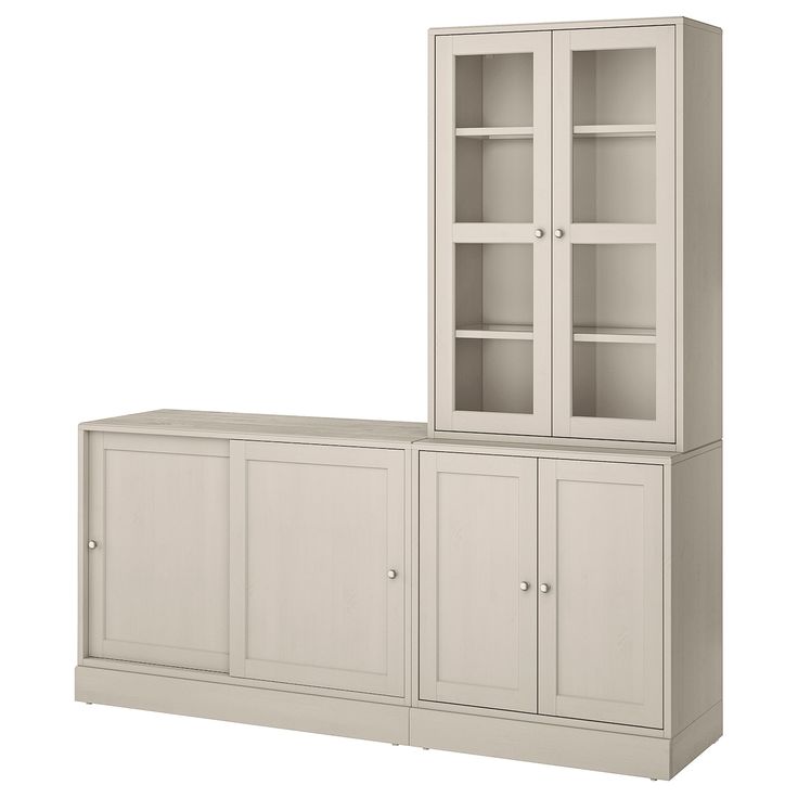 a white cabinet with glass doors and shelves on the top, against a white background