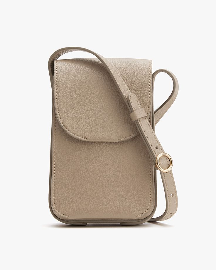 Small vertically oriented shoulder bag with strap and front flap closure. Classic Crossbody Phone Bag For On-the-go, Chic Phone Bag With Detachable Strap For Travel, Chic Travel Phone Bag With Detachable Strap, Chic Phone Bag With Adjustable Strap For Travel, Chic Travel Phone Bag With Adjustable Strap, Modern Crossbody Phone Bag With Removable Pouch, Classic Phone Bag With Detachable Strap For Travel, Versatile Business Phone Bag With Removable Pouch, Versatile Business Crossbody Phone Bag