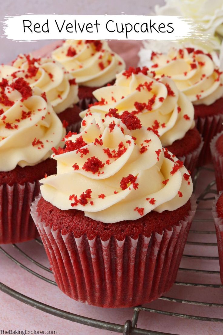 red velvet cupcakes with white frosting and sprinkles