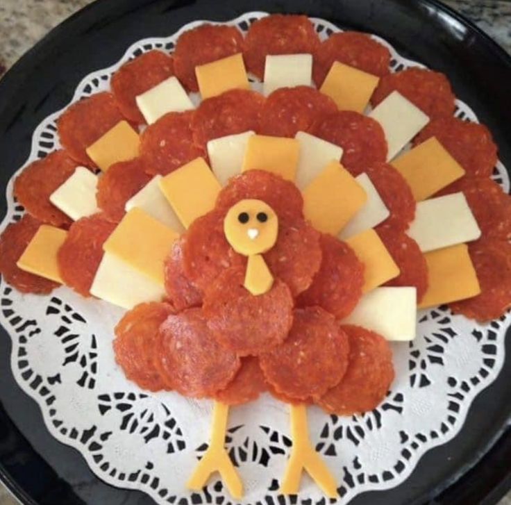 a turkey made out of cheese and meat on a plate