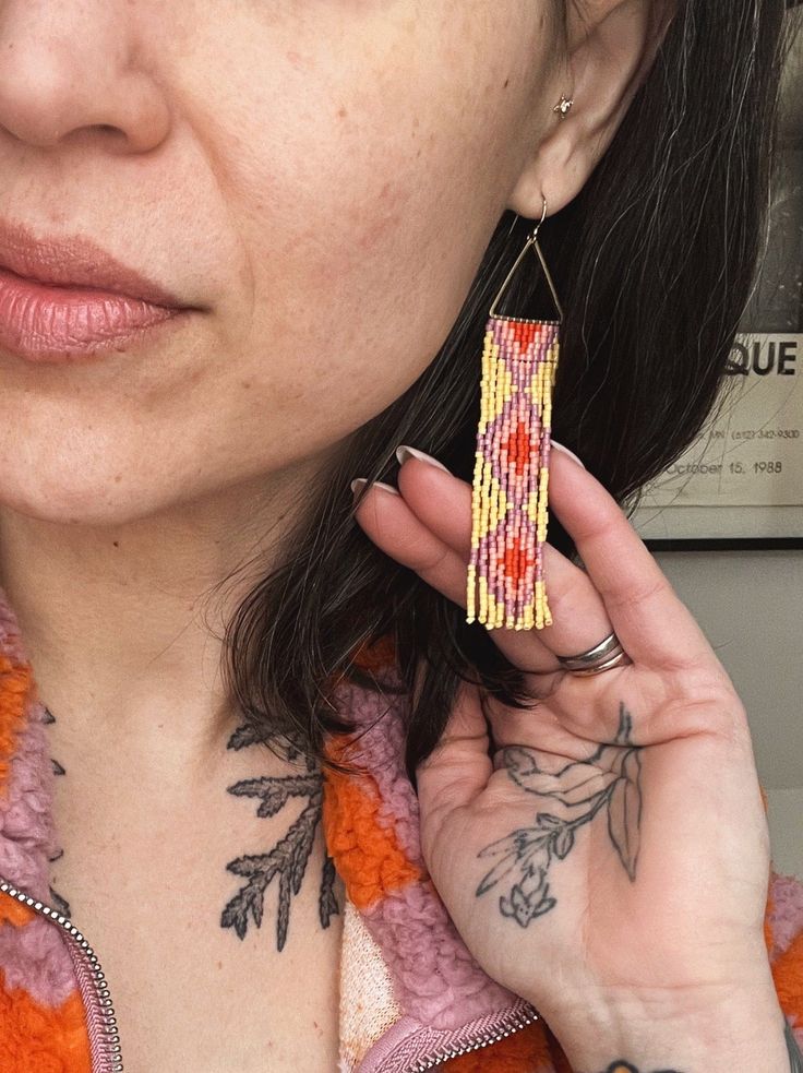 Sinti Tuklo in the Choctaw language translates to "snake two". This beautiful diamond pattern is my second interpretation of a traditional Choctaw pattern that represents the rattlesnake and respect for nature. These hand-beaded earrings with an unfinished open large triangle metal top have eleven fringes with a modern take on the traditional Choctaw diamond pattern. Sinti Tuklo contains 572 delicate glass beads in each earring. Sinti Tuklo is 3.5" long. Metal findings may show a natural patina Choctaw Language, Diamond Pattern, Beaded Earrings, Glass Beads, How To Apply, Pattern