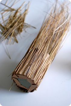 a bundle of straw sitting on top of a white table