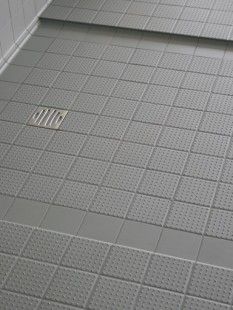 a bathroom with a shower and tiled floor