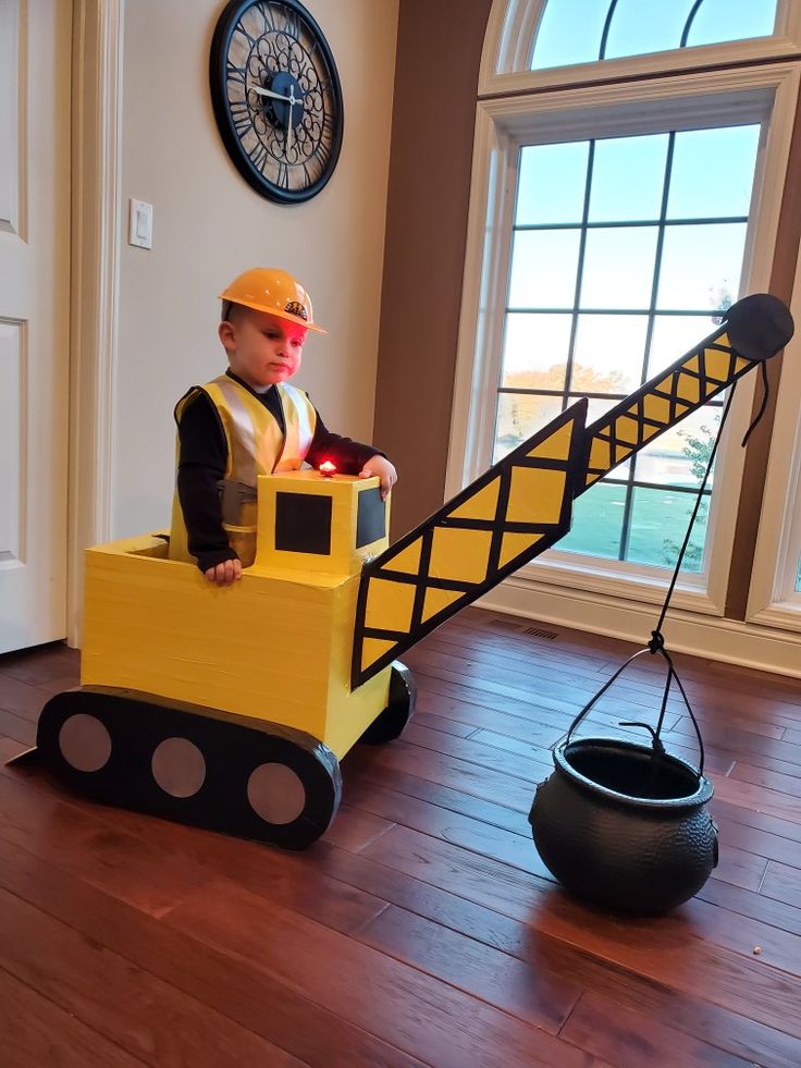 a small child in a construction themed costume