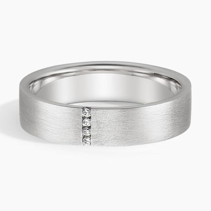 a white gold wedding ring with three diamonds on the inside and outside, set in 18k white gold