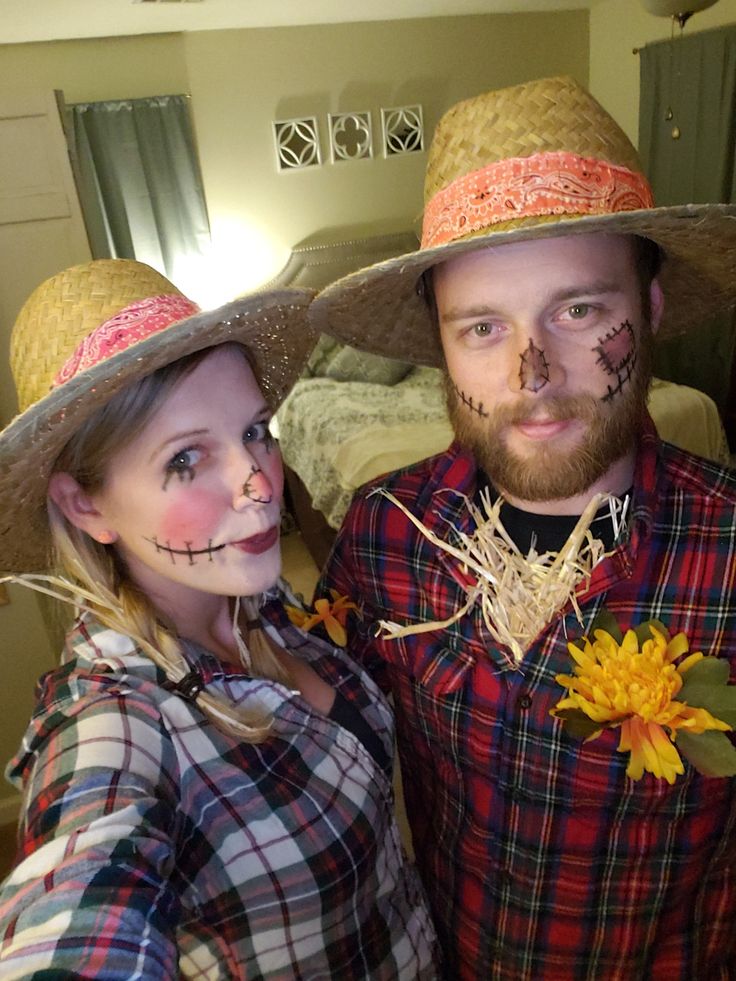 a man and woman wearing scarecrow costumes