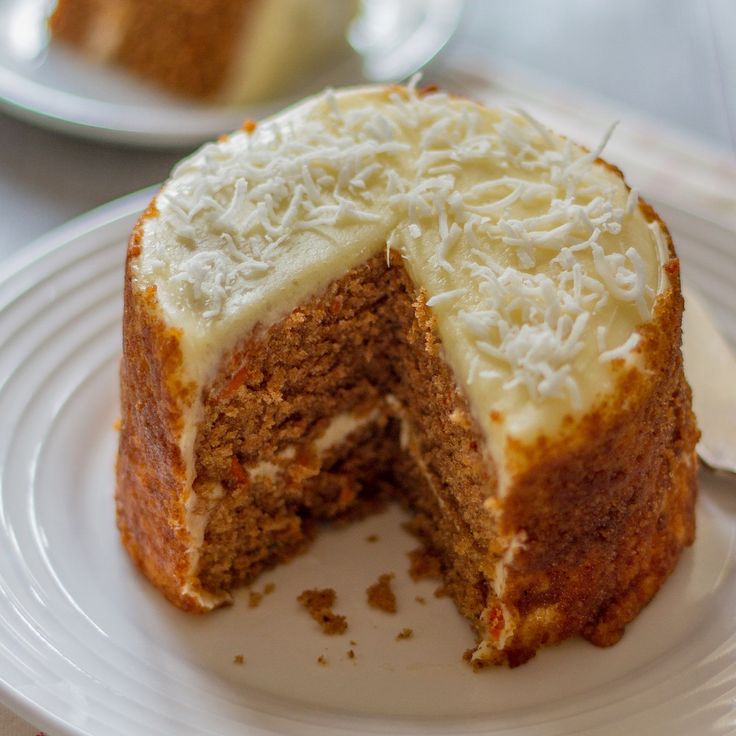 there is a cake that has been cut in half on the plate and ready to be eaten