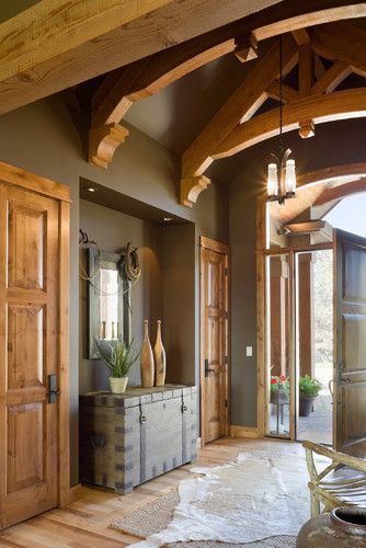 an entry way with wooden doors and windows