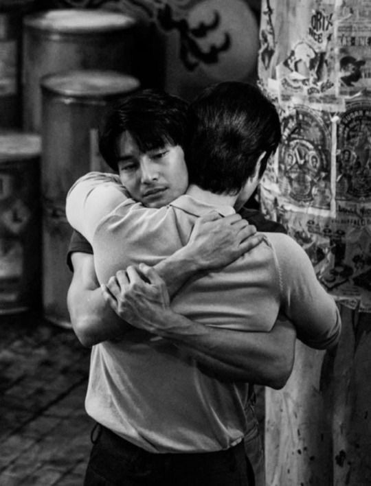 black and white photograph of two people hugging each other