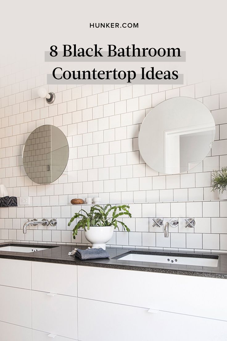 a bathroom with white tiles and black countertops is featured in the article, 8 black bathroom countertop ideas