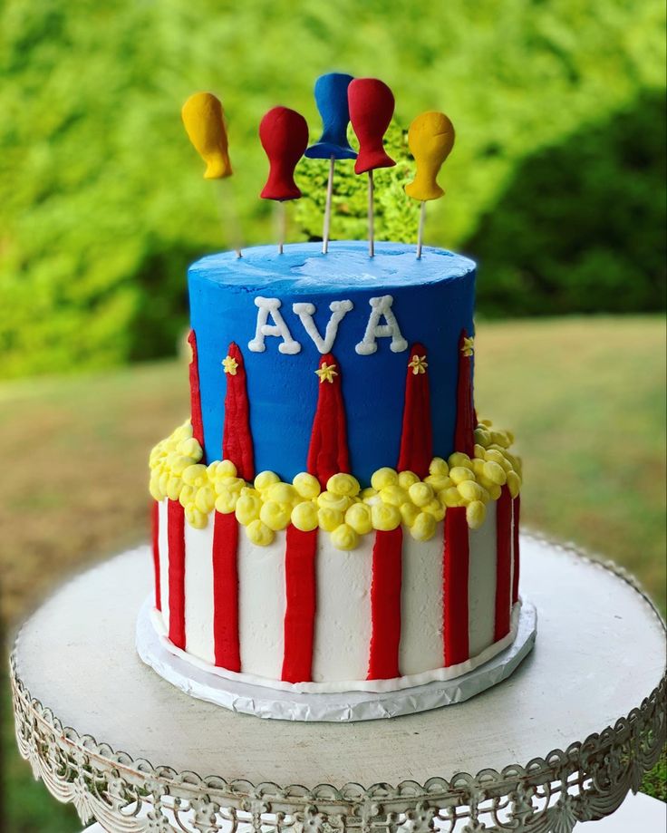 a blue and red striped cake sitting on top of a table