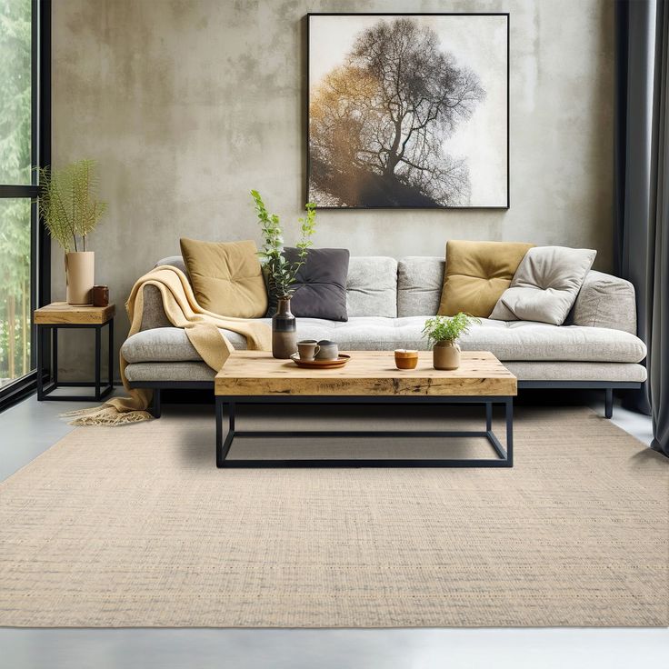 a living room filled with furniture and a painting on the wall above it's coffee table