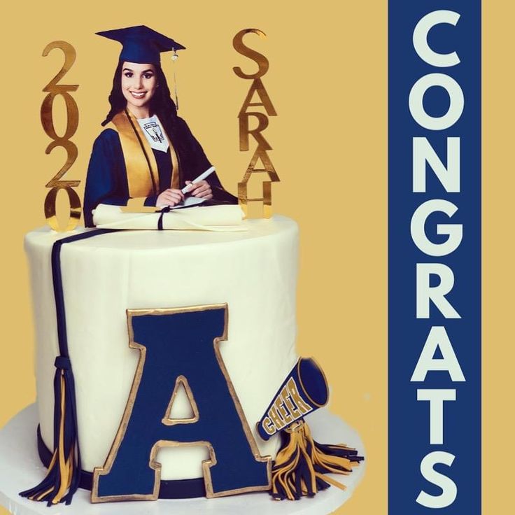 a cake with the letter a on it and a graduate's cap sitting on top