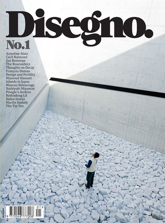 a magazine cover with a man standing in the middle of a rock strewn area and text reading disegno no 1