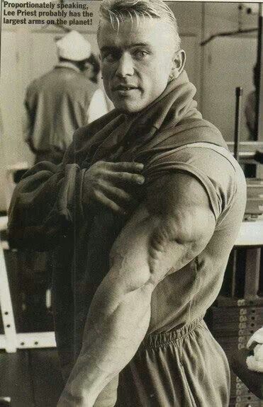 an old black and white photo of a man flexing his muscles