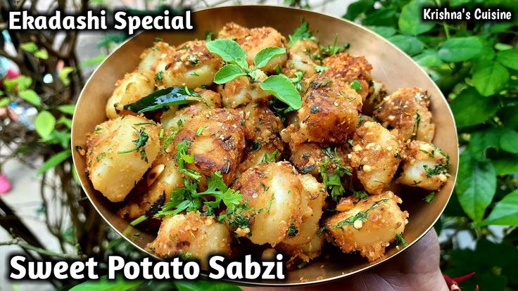 a person holding a bowl full of food with the caption sweet potato sabzi