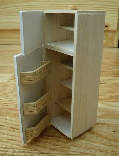 an open wooden cabinet sitting on top of a hard wood floor