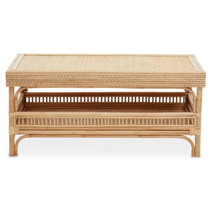 a coffee table with wicker top and shelf on the bottom, against a white background