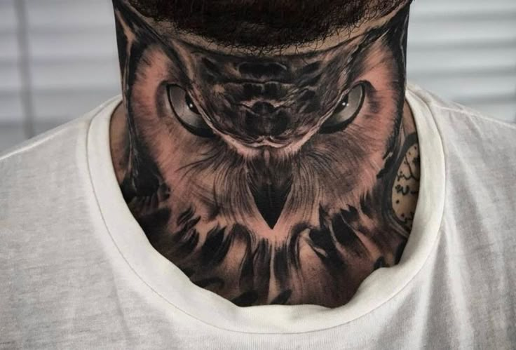 a man with an owl tattoo on his neck