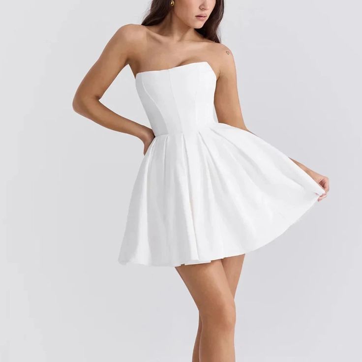 Elevate your wardrobe with this elegant strapless mini dress, meticulously designed for a perfect fit and flare effect. The timeless A-line style complements a corset style bodice, offering both comfort and allure. Ideal for everything from formal gatherings to casual celebrations, this dress adapts effortlessly to any occasion. The craftsmanship highlights a dedication to detail and quality, ensuring you look impeccable all night long. Choose from a variety of colors and sizes to find your perf Chic A-line Mini Dress With Lined Bodice, A-line Mini Dress With Boned Bodice, Elegant A-line Lined Corset Dress, Chic A-line Corset Dress With Lined Bodice, Prom Mini Dress With Pleated Bodice, Pleated Bodice Mini Dress For Prom, Chic White Fit And Flare Corset Dress, Elegant Fit And Flare Corset Dress For Night Out, Feminine A-line Strapless Evening Dress