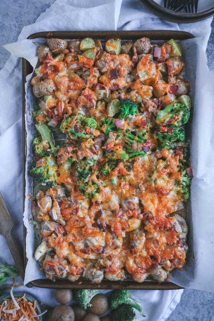 a casserole dish with broccoli, cheese and meat