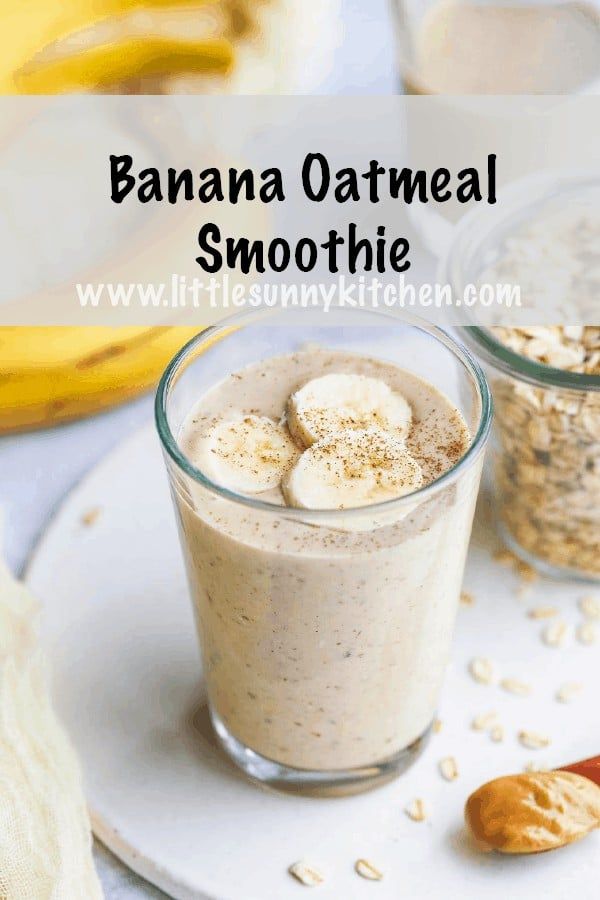 banana oatmeal smoothie in a glass on a white plate with bananas