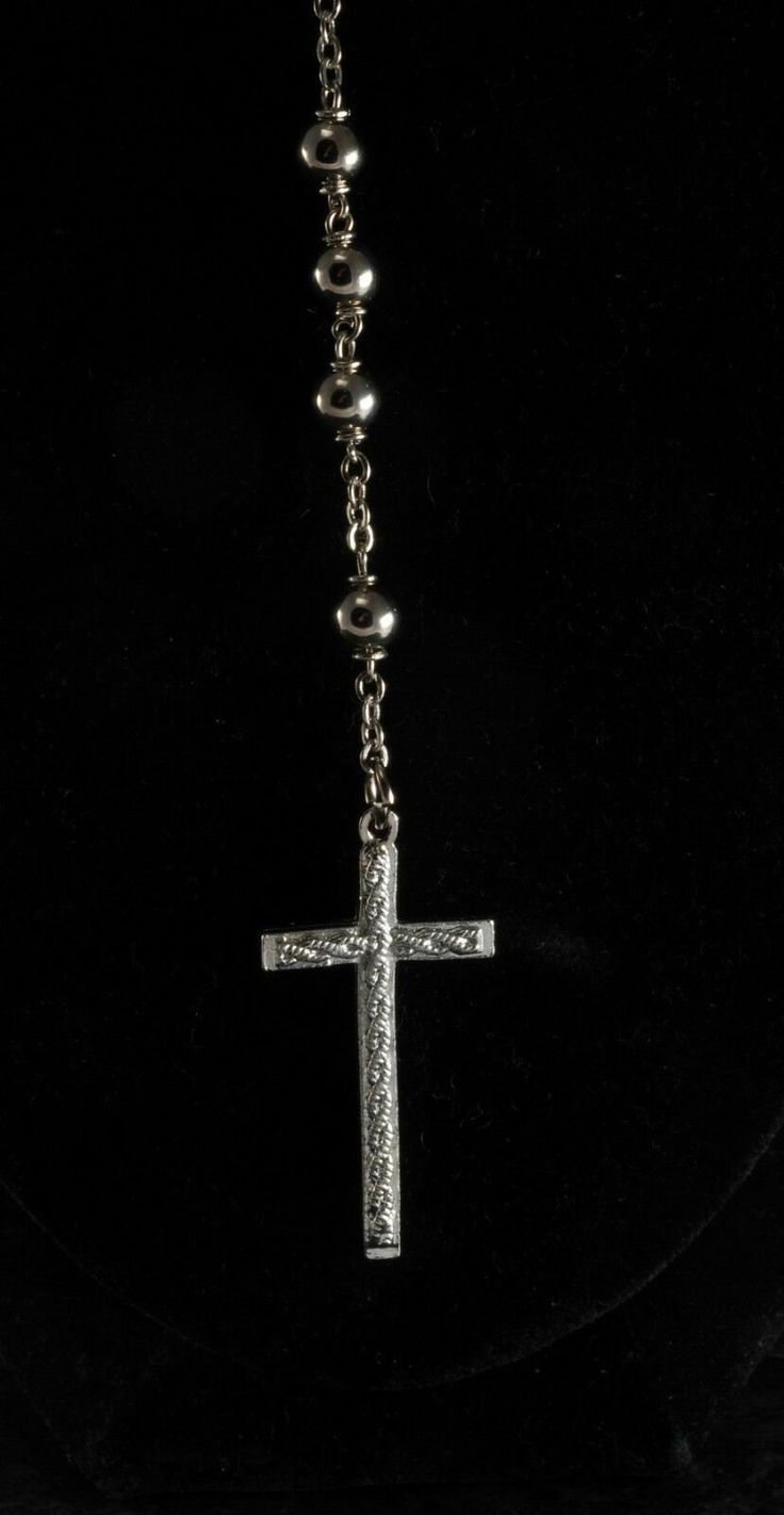 "For sale is a vintage rosary beaded cross necklace. This necklace is silver tone metal with silver tone metal beads. The cross measures 3/4 x 1 1/2\". The rosary chain measures 24\" with a 3 1/2\" drop. New Treasures added all the time. Check back often!" Silver Cross Jewelry With Beaded Chain, Silver Beaded Cross Jewelry, Silver Cross-shaped Jewelry With Beaded Chain, Silver Cross Rosary, Silver Beaded Crucifix Jewelry, Silver Cross Rosary Bracelet, Traditional Silver Beaded Rosary, Bead Cross Necklace, Spiritual Silver Cross Rosary