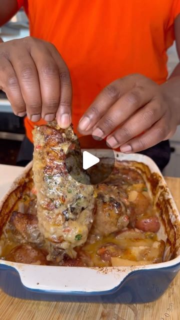 a person cutting up food in a pan on top of a wooden table with an orange shirt