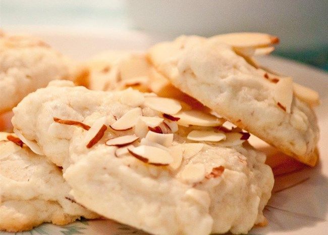 some cookies with almonds are on a plate