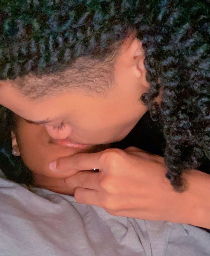 a close up of a person with dreadlocks on their head looking down at something