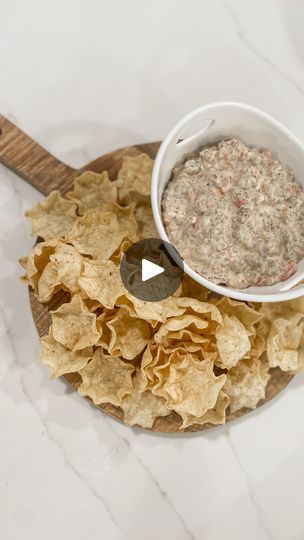 a bowl of dip surrounded by tortilla chips